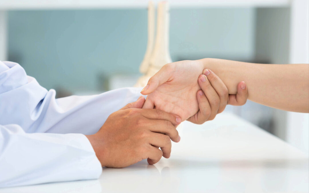 Doctor Looking at Wrist Sprain